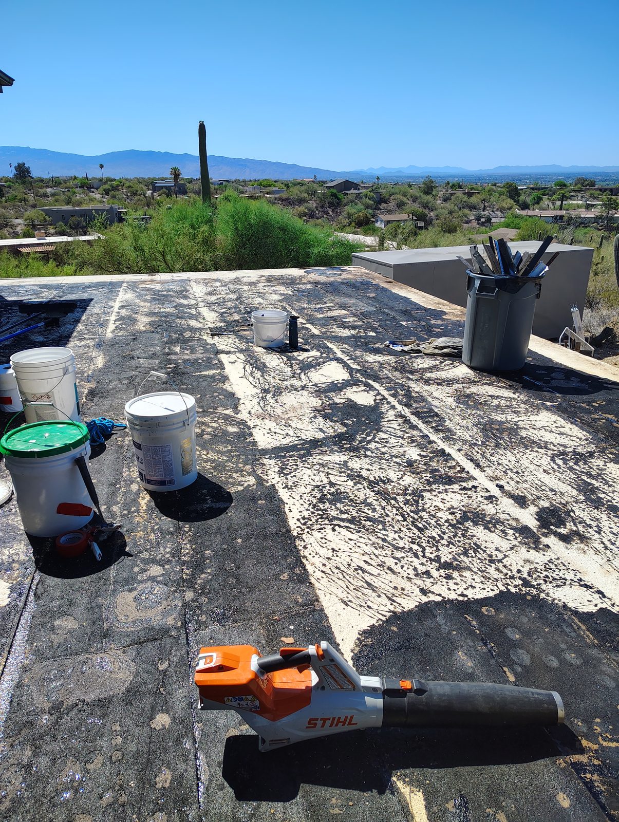 Roof restoration in progress in Tucson, new white coating going over the prepared surface